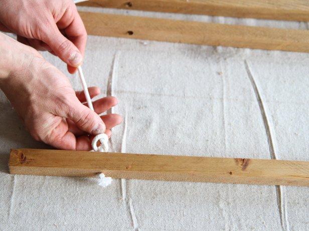 Tie a knot in the rope between each wood dowel to make a stylish doormat.