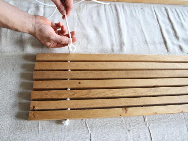 Tie a knot between each wood dowel to make a stylish doormat.