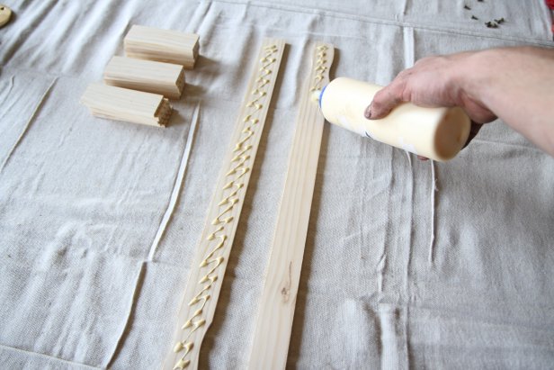 Apply wood glue to two full-length paint sticks.
