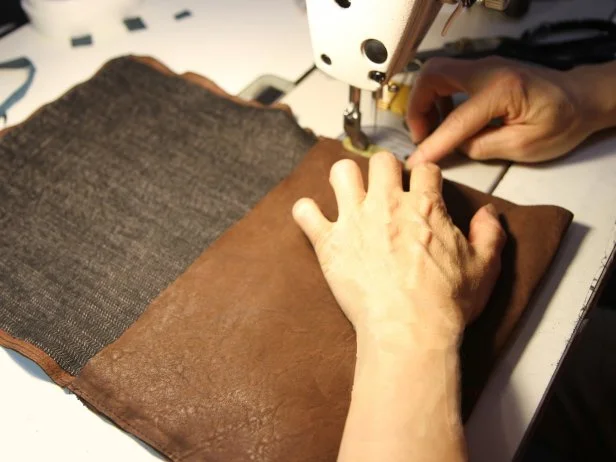 Sew the seam and continue the stitch around the perimeter of the leather flap to make an iPad case.