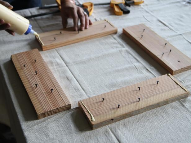Run a bead of wood glue on each end of two of the planks.