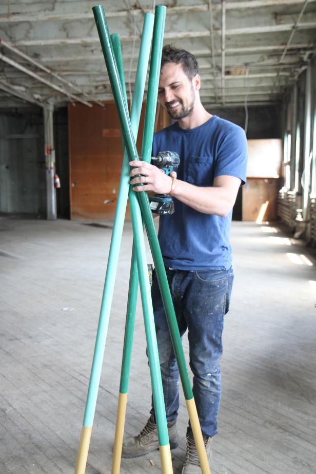 Dan Faires attaches poles together to make a coat rack