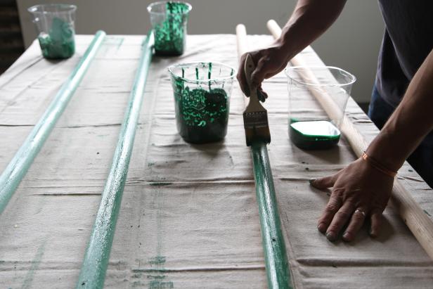 Paint coat rack legs with different shades of green paint.