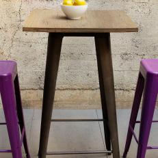 Simple Outdoor High-Top Table With Vibrant Purple Stools