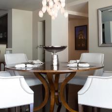 White Contemporary Dining Area With White Leather Chairs