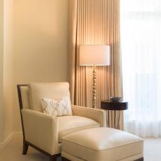 White Armchair and Ottoman With Floor Lamp