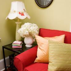 Vibrant Red Couch in Cottage Style Living Room
