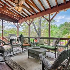 Beautiful Covered Deck Features Gray Wicker Seating, Grills & Space For Entertaining