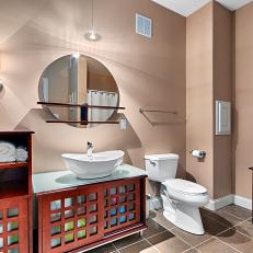Fun, Updated Transitional Bathroom Features Contemporary Vessel Sink & Spa-Like Storage