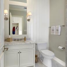Traditional Guest Bathroom with White Paneling and Marble Tile and Countertops