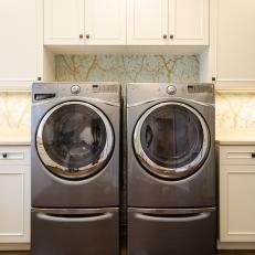 Laundry Room Surprises With Elegant Tree Silhouettes in Gold & Simple Cabinetry
