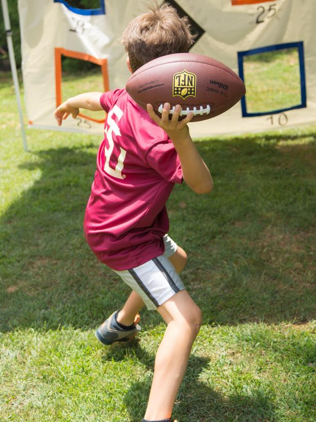 Guests score points by throwing a football through the numbered holes.