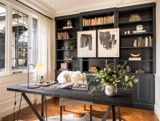 Home Office With Black Bookcase and Charred Wood Desk
