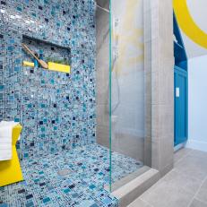 Blue Mosaic Tile Spills From Shower Onto Floor to Create Pooling Effect