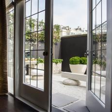 Private Garden Sits Just Beyond Leaded Glass French Doors
