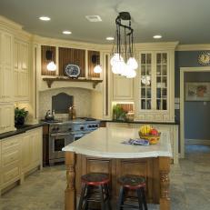 Traditional Kitchen Features Cream Cabinetry & Wood Island