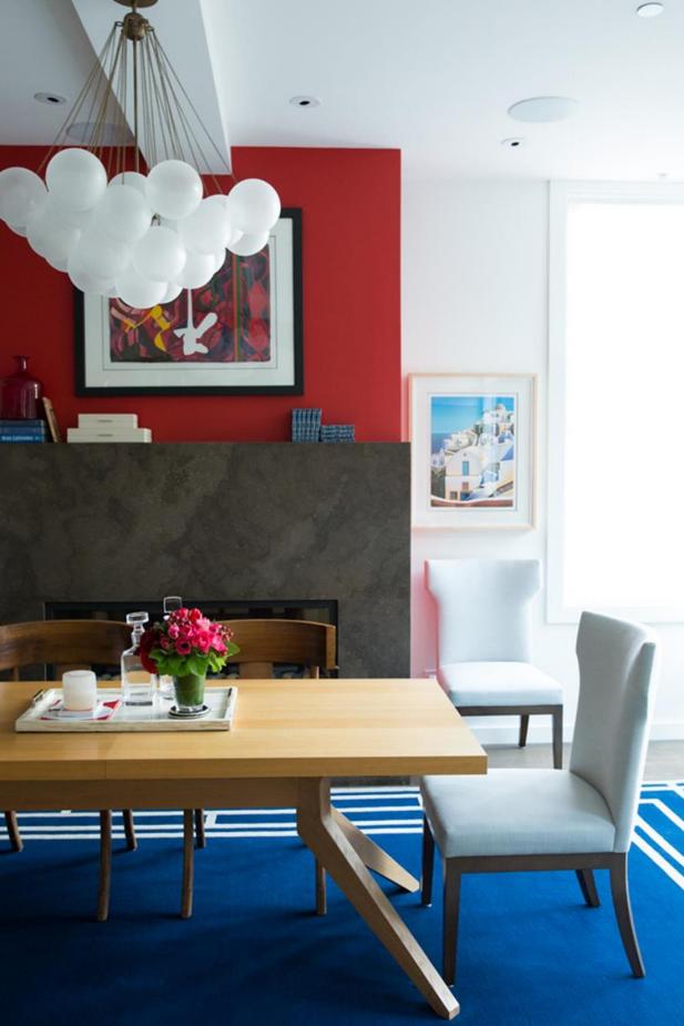 Modern Dining Room With Red Accent Wall & Royal Blue Rug