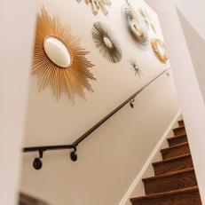 Staircase With Rich Wood Stairs and Starburst Mirrors