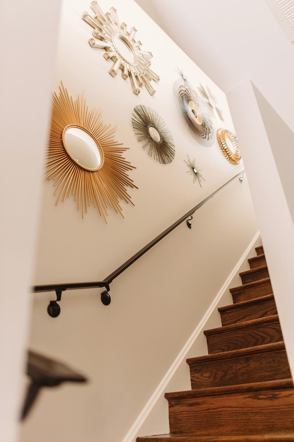 Staircase With Rich Wood Stairs and Starburst Mirrors | HGTV