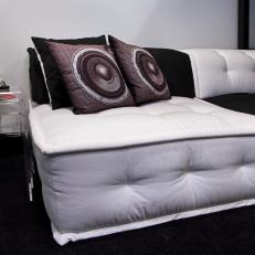 Sectional With Alternating Black and White Cushions & Speaker Throw Pillows