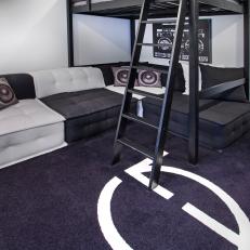 Modern Loft Bed With Black and White Sectional Below and Striped Ceiling Above 