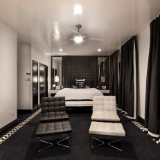 Mod Black and White Bedroom Featuring Tufted Leather Chairs