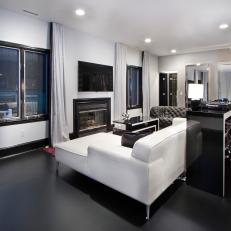 Modern Black and White Living Room Featuring White Leather Sectional, Black Matte Floor and White Curtains With Black Trim