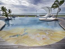 Modern Curved Swimming Pool With Beach Inspired Floor Mural, Covered White Hammock and Wooden Deck 