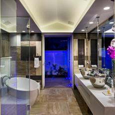 Modern Bathroom With Large Silver Vessel Sinks, Long Hanging Faucets and White Oval Bathtub 