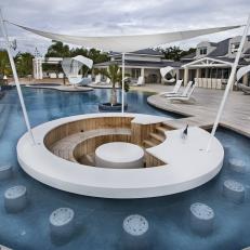 Built In In-Pool White, Circular Bar With Canvas Cover and Surrounding Underwater Stone Stools