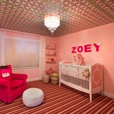 Girl's Pink Nursery With Striped Floor, Patterned Ceiling and Hot Pink Arm Chair With White Floor Pillow Ottoman 