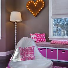 Lively Hot Pink and White Girls Nursery With Decorative Throw Pillows, Large Bean Bag Chair and Heart Light