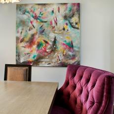 Rich Burgundy Tufted Bench at Head of Wood Dining Table With Complimentary Abstract Art Canvas