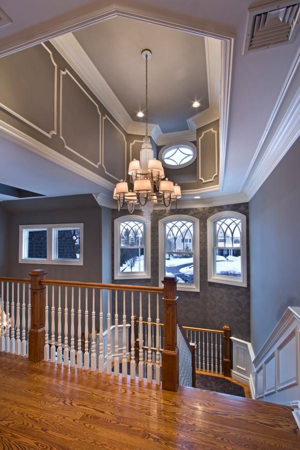 Second Story View of Open Staircase With Charcoal Wallpaper Accent Wall