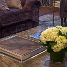 Close Up on Traditional Wood Coffee Table Decorated With Hydrangeas, Cased Book and Silver Boxes 