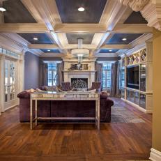 Long View of Contemporary Living Room With Coffered Ceiling, Purple Velvet Sofa and Transition From Mustard Yellow to Gray Walls 