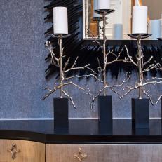 Close up on Buffet Top Decor Including Silver Twig Candlesticks and Spiky Black Mirror Frame 