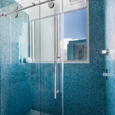 Shower With Blue Mosaic Tiles and Window