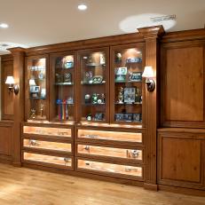 Handsome Memorabilia Cabinets With Sophisticated Lighting in Basement