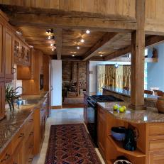 Contemporary Wood Kitchen with Exposed Beams and Marble-topped Kitchen Island