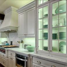 Glass-Front Cottage Style Kitchen Cabinet Showcases Mint Green Dishware
