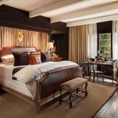 Brown Master Bedroom with White Beamed Ceilings, Leather Bed and Velvet Upholstered Walls 