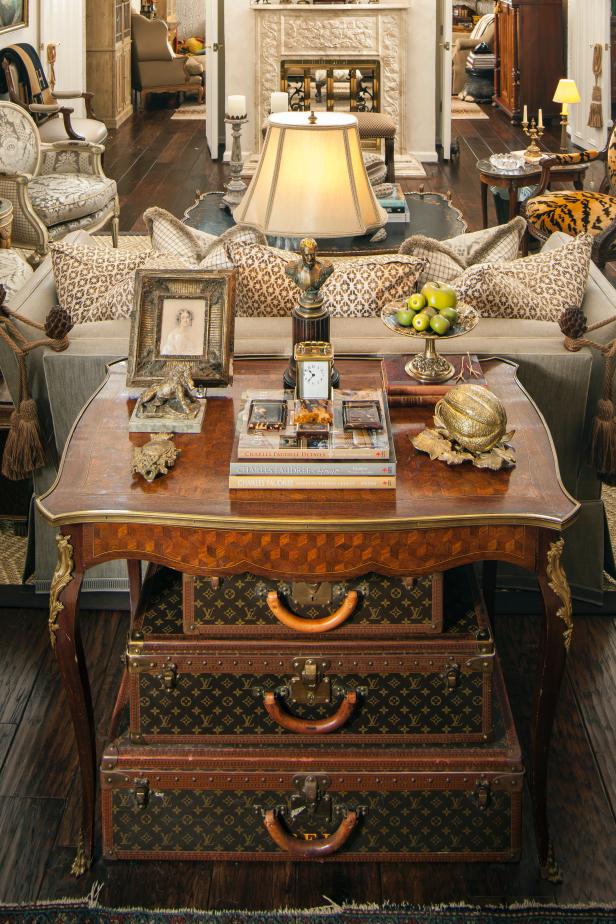 Table with Antiques and Louis Vuitton Suitcases