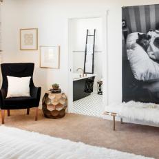 Sitting Area in Master Bedroom with Chair, Bench and Large Black-and-White Photo