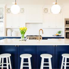 Navy Blue and White Kitchen Featuring Large Cabinets and Kitchen Island with Stools