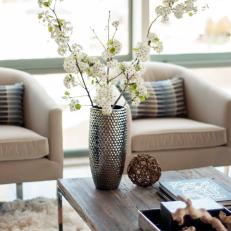 Sitting Area Features Flowering Plant in Chrome Vase & Neutral Armchairs