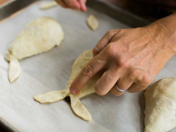 Using excess dough, cut 'leaves' and attach to the top of the pear with a dab of milk.