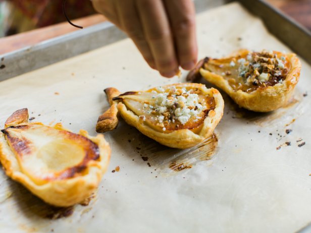 Allow pears to cool. Flip them over to fill scooped centers with blue cheese, then sprinkle with chopped walnuts