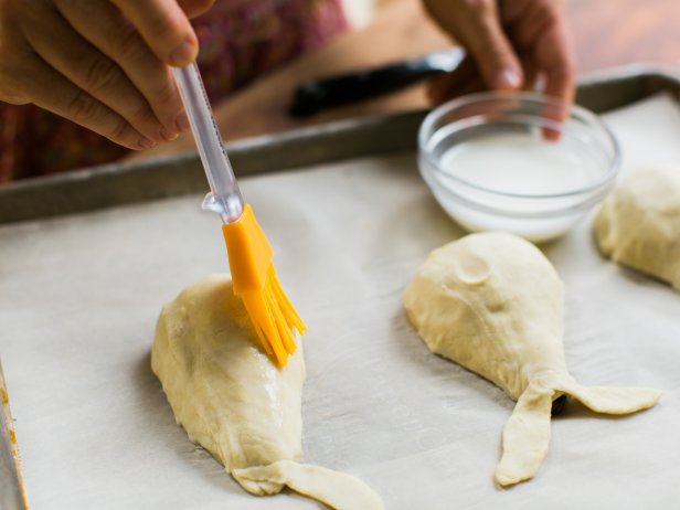 Prick dough all over with a knife or fork, then brush pears with milk.