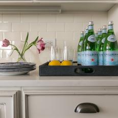 Stainless Steel Cabinet Hardware and White Subway Tile Backsplash in Neutral Country Kitchen